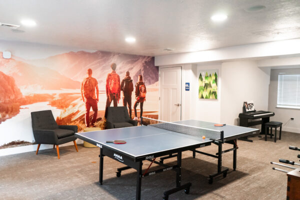 Apartment community clubhouse with ping pong, foosball, & piano